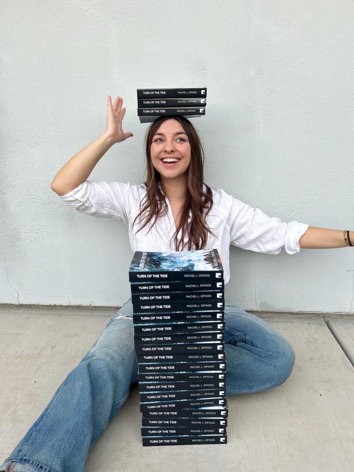 Rachel Ertassi with her books