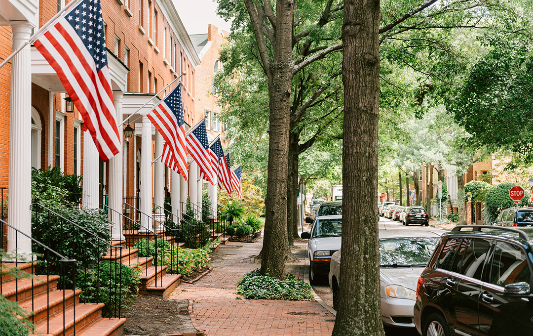 street view of houses with American flags