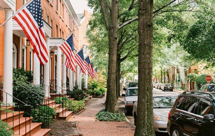 street view of houses with American flags
