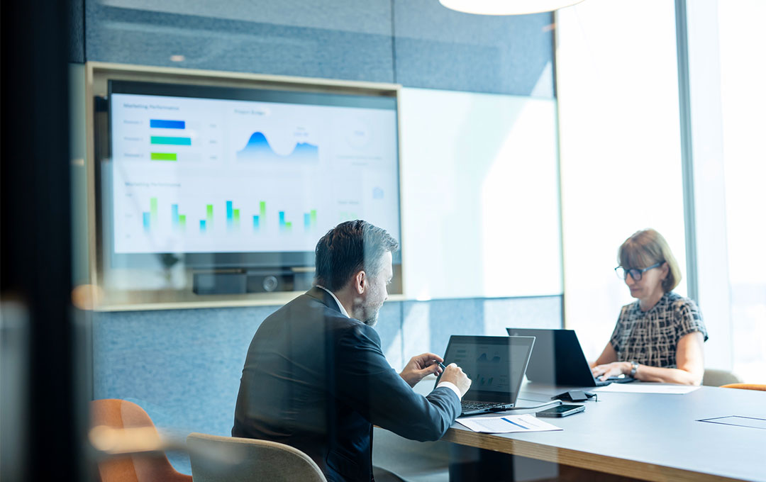 People in meeting room discussing finance