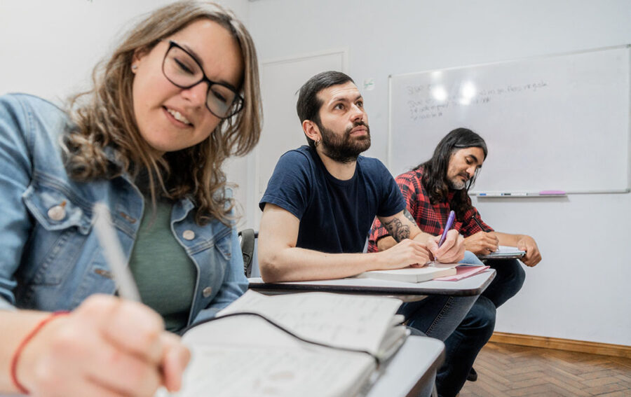 student listening and taking notes