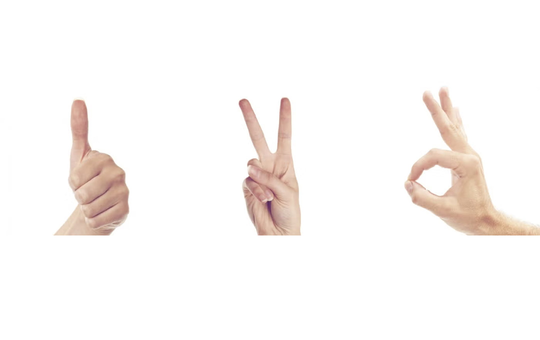 Three hand gestures on a white background: a thumbs-up, a peace sign, and an OK sign displayed side by side.