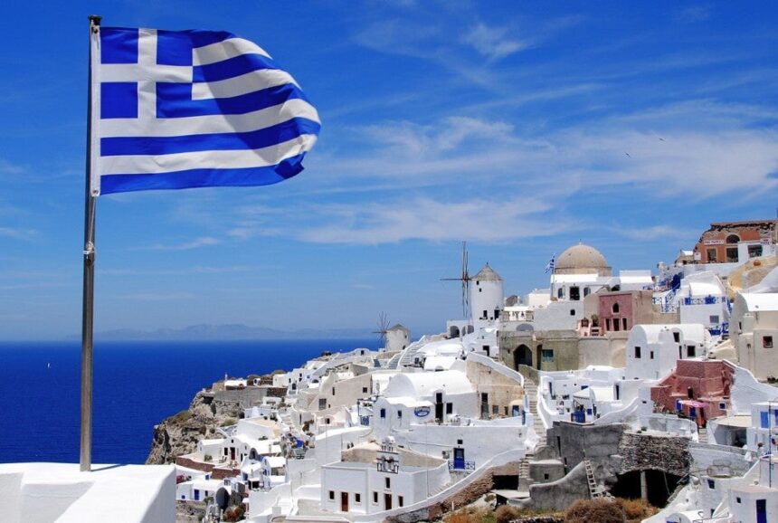 Greek flag and cliffside houses
