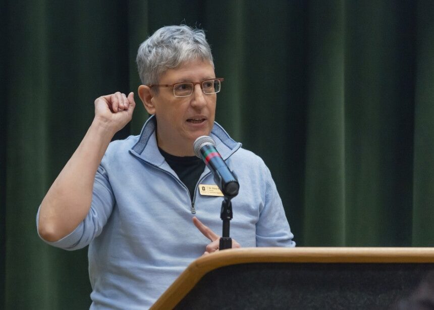Dana Kivel speaks at a podium