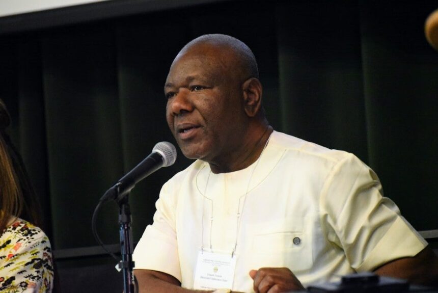 Dr. Ernest Uwazie speaking into a microphone