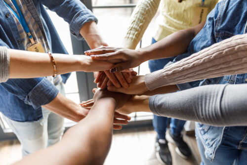 Close-Up Shot Of Individuals Forming A United Front