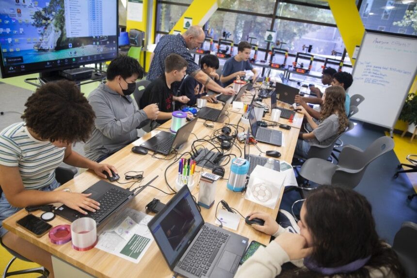 K-12 students work inside Sac State's StingerStudio Makerspace during the Introduction to 3D Printing and Design Summer Youth Academy