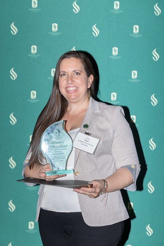 Anna Keck posing with her Woman of Influence award