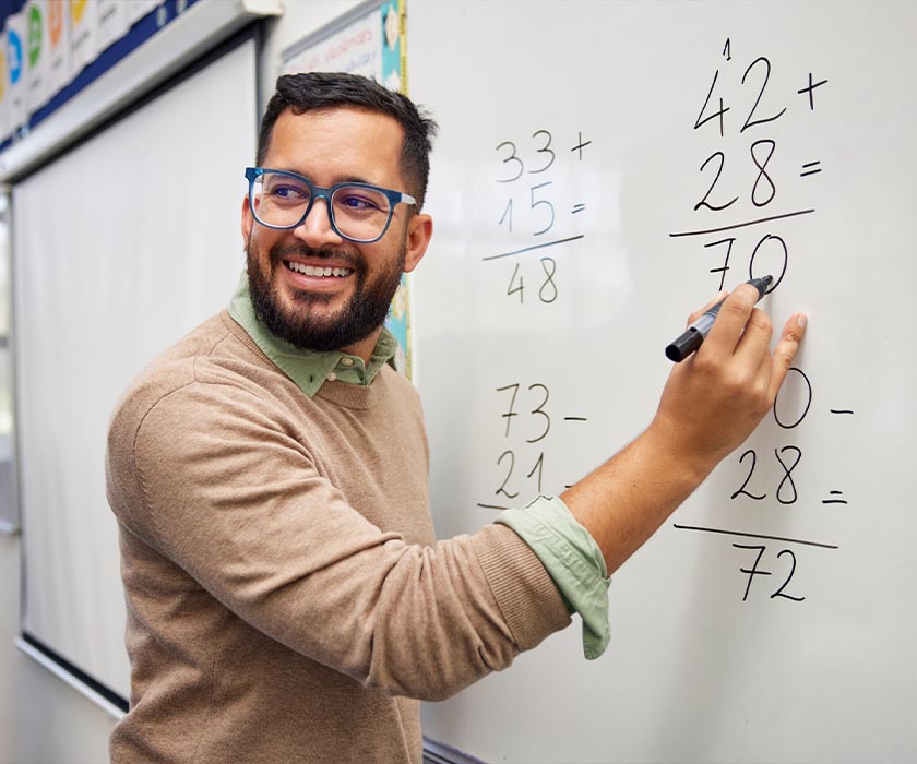 Teacher Writing On Whiteboard