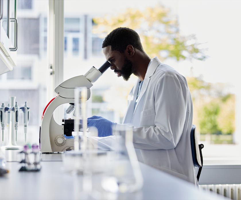 Doctor Looking Into Microscope