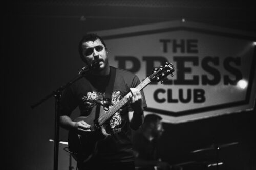 Man Playing Guitar On Stage