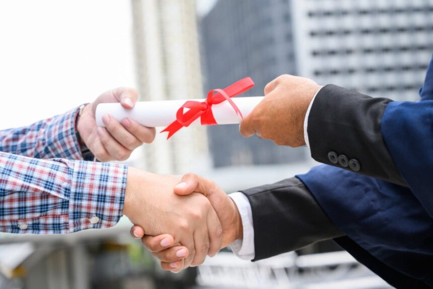 Diploma exchanging hands