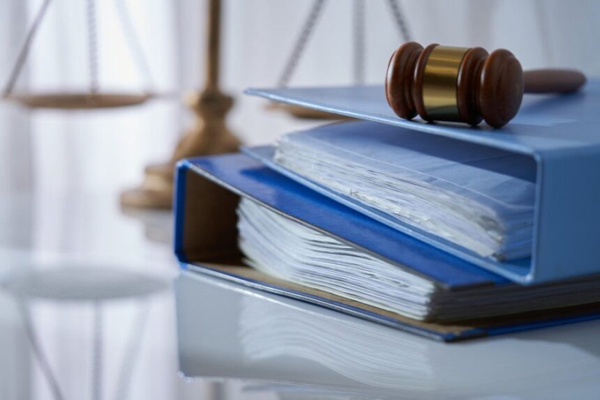 A gavel hammer on a stack of documents.