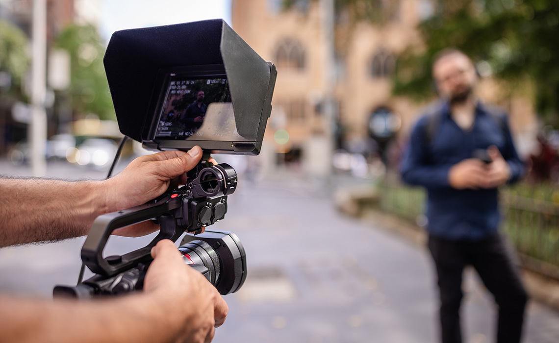 Filmmaker Using Camera To Capture Footage Of A Subject In Sydney, Australia
