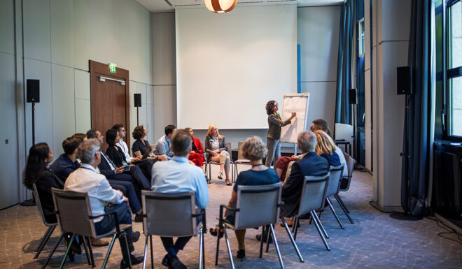 Businesswoman explaining strategy over a flip chart