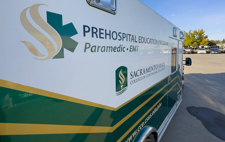 Sacramento State College of Continuing Education ambulance featuring Prehospital Education Program branding for Paramedic and EMT training, parked outdoors.