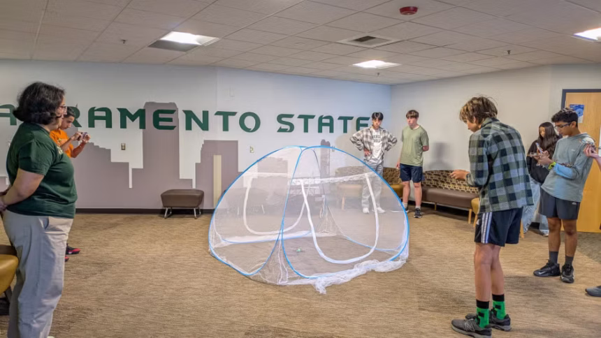 Students using drone technology in a building